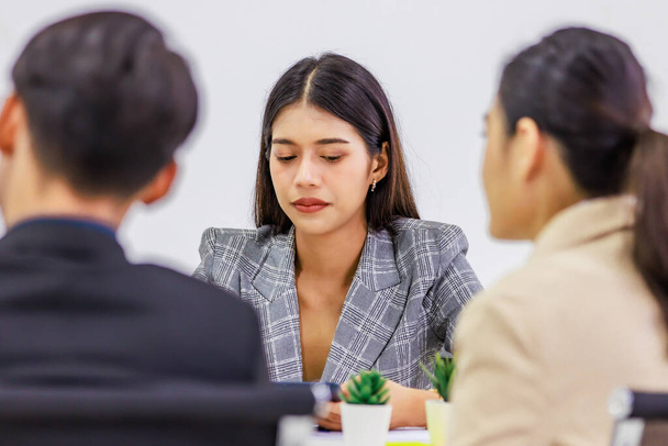 Millennial Asian professional successful male female businessman businesswoman group in formal suit discussing brainstorming sharing business solution ideas in company conference meeting room. - Photo, image