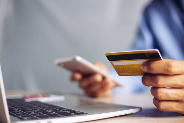 Online payment hands holding credit card and using laptop. - Fotografie, Obrázek