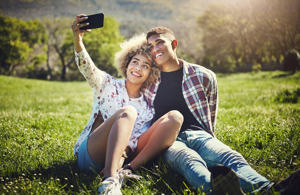 Im making this one my profile picture. a young couple taking a selfie while spending the day at the park - Fotoğraf, Görsel