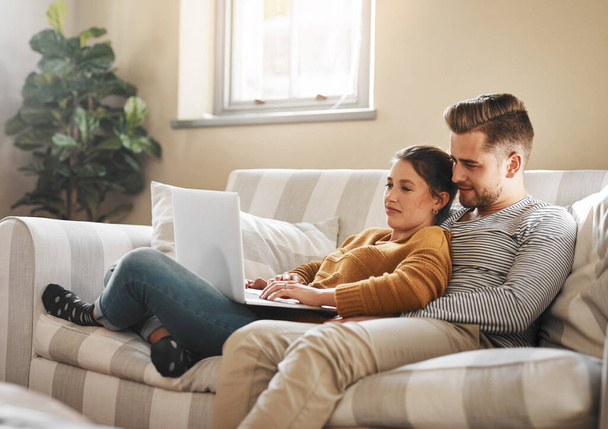 I dont see any listings that I like, babe. a young couple using a laptop while relaxing at home - Fotoğraf, Görsel