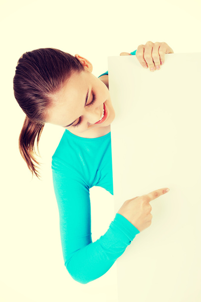 Portrait young happy woman with blank board - 写真・画像