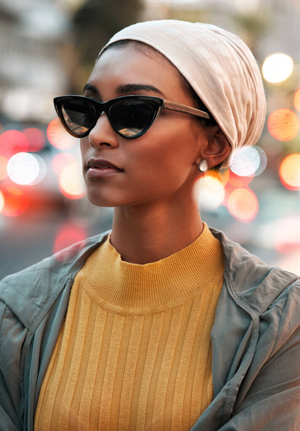 Looking for the next place to visit. an attractive young woman wearing a hijab and sunglasses while touring the city - Foto, Imagen