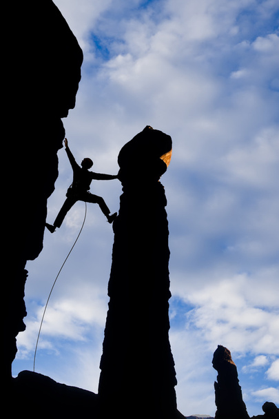 Rock climber reaching across a gap. - Photo, Image