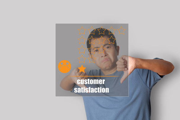 Young man showing thumb down sign by hand, Choosing sadness emotion face screen. bad service dislike bad quality, low rating, social media not good. Concept of customer experience dissatisfied. - Fotoğraf, Görsel