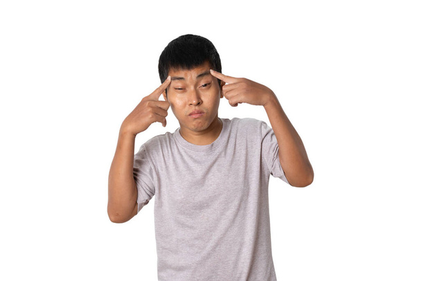 Portrait of young man pointing to the eye. Human emotion face expression concept. Studio shot isolated on white background. copy space. - Zdjęcie, obraz