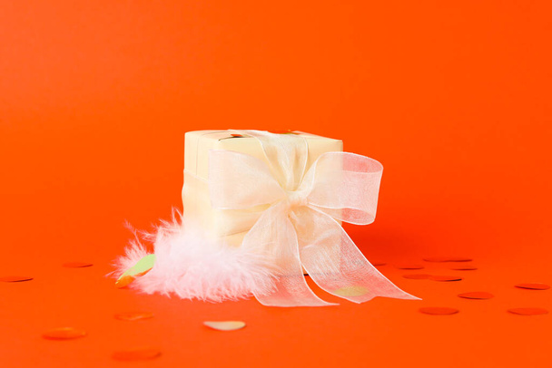 Concept of gift, gift box on orange background - Foto, afbeelding