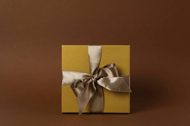 Concept of gift, gift box on brown background - Φωτογραφία, εικόνα
