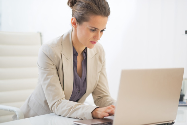 Business woman working on laptop in office - Photo, image
