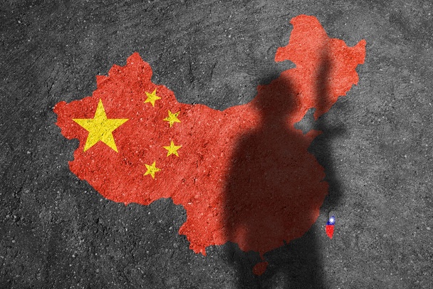 China and Taiwan flag map painted on a concrete wall with soldier shadow - Foto, Imagem