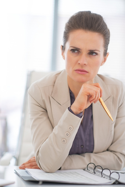 Portrait of thoughtful business woman in office - Photo, Image