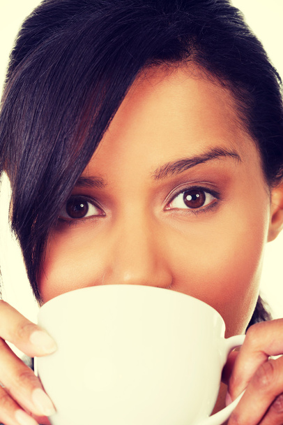 Young woman drinking something from big mug - Foto, Imagem