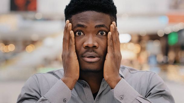 Close-up male portrait young surprised stunned excited shocked serious african american man holding hands on face surprise saying wow getting unbelievable sad news feeling shock surprise amaze wonder - Φωτογραφία, εικόνα