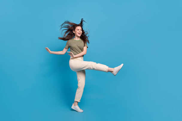 Full size photo of cute young brunette lady dance wear casual cloth isolated on blue background. - Foto, immagini