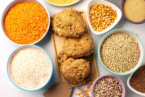 Gluten free, Healthy eating, dieting, balanced food concept. Bread gluten-free, millet, quinoa, polenta, buckwheat, rice, chickpea on white background. Top view, copy space.  - Photo, image