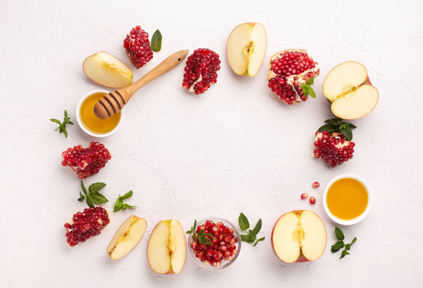 Rosh Hashanah, Jewish New Year Autumn Holiday Concept. Apples, Honey, Pomegranate, Traditional Products for Celebration on White Stone Background. - Foto, Imagem