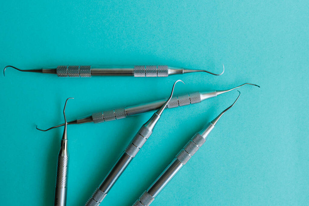 Dental instruments made of medical steel lying on a blue background - Foto, immagini