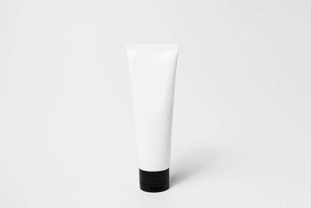 Close-up of cosmetic tube bottle of black and white isolated on white background. - Foto, afbeelding