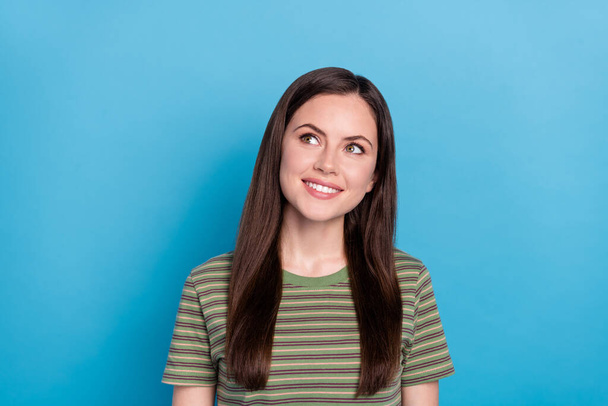 Photo of impressed young brunette lady look up wear green t-shirt isolated on blue color background. - Foto, Imagen