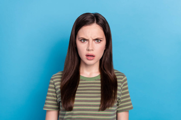 Photo of sad millennial brunette lady wear green t-shirt isolated on blue color background. - Foto, afbeelding