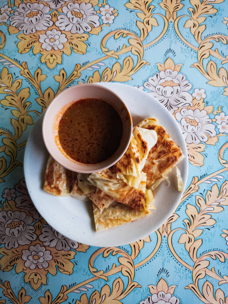 Top view of roti canai served with bowl of curry - Fotografie, Obrázek