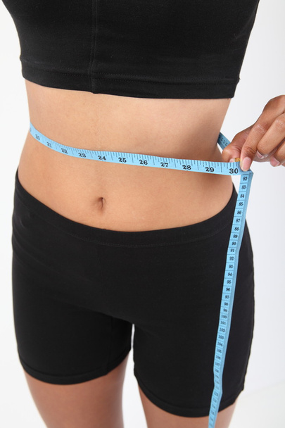 Measuring waist of a slim woman - 写真・画像