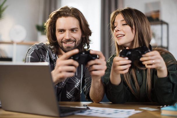 Games, entertainment, family, leisure concept. Close up of young caucasian family, holding joysticks and enjoying their free time playing new games at home. - Foto, afbeelding