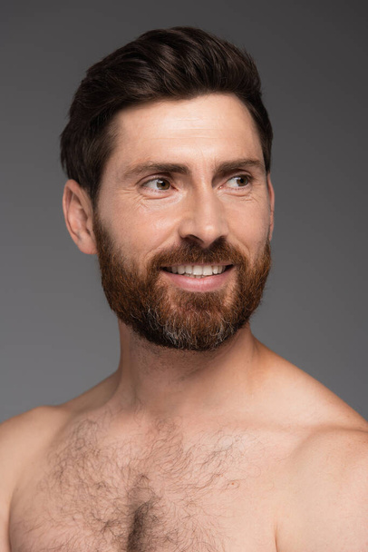 portrait of shirtless and happy man with hair on chest smiling isolated on grey - Photo, Image