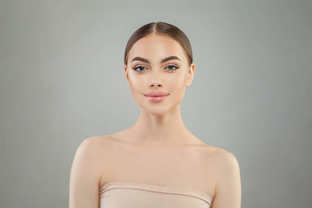Calm young woman with healthy clean skin. Facial treatment, skincare and spa concept - Photo, image