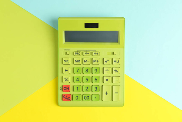 Modern calculator on color background, top view - Foto, afbeelding