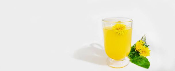 Dandelion tea in a glass cup on a uniform background, a natural product from Taraxacum protects against diseases, dandelion herbal tea improves cellular health, helps in weight loss. Banner - Фото, зображення