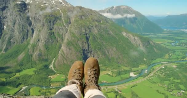 POV of a hiker or tourist sitting on mountain with nature view landscape on a beautiful sunny day while recording on a handheld camera. Hiking, adventure seeking person relaxing in Romsdalen, Norway. - Filmagem, Vídeo