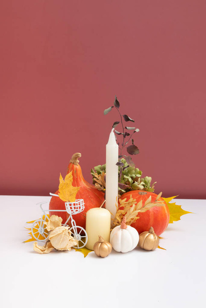 Autumn composition. Dried leaves, pumpkins and candles on white pink background. Autumn fall and thanksgiving day concept. Still life. - Valokuva, kuva