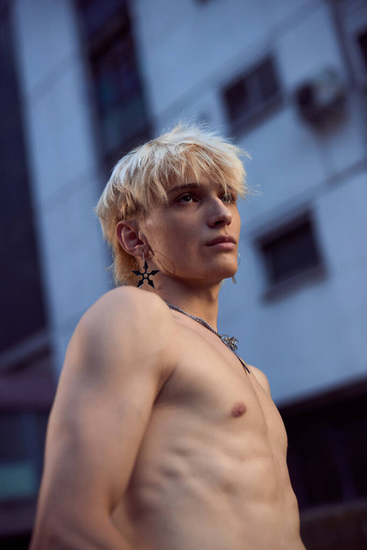 Portrait of a blonde shirtless teenage boy in the urban exterior. - Fotografie, Obrázek