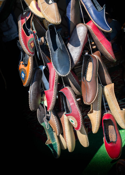 Set of traditional hand made leather shoes in a bazaar - Photo, Image