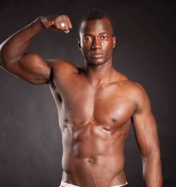Beautiful and muscular black man in dark background - Foto, immagini