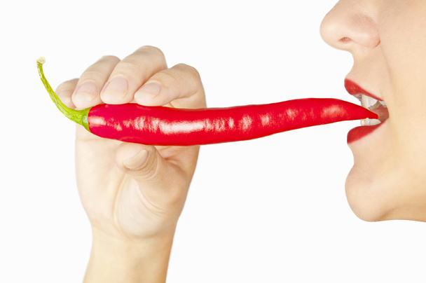 Nő a fogát elszigetelt fehér piros chili paprika - Fotó, kép
