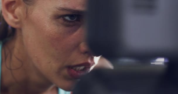 Fit, active and healthy woman sweating in gym workout, exercise and training for cardio health, stamina or endurance. Closeup headshot, face and slow motion of motivated, determined or sporty athlete. - Filmagem, Vídeo
