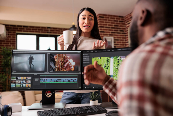 Creative team of editors working with editing software, creating professional movie footage with color grading and visual effects. Videographers team editing post production montage. - 写真・画像