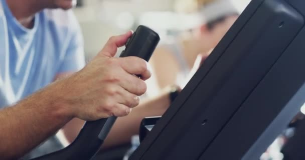 Serious, active and sporty man during a spinning class at the gym. Fit male using bikes for cardio exercise in a fitness facility while feeling determined and sweaty in a health and wellness club. - Filmagem, Vídeo