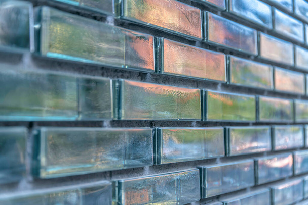 Close-up of a glass brick walls with reflective texture at Austin, Texas. Running bond pattern of a glass bricks with glossy exterior. - Photo, Image