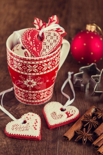 Heart shaped gingerbread cookies on red cup with christmas decor - Photo, Image