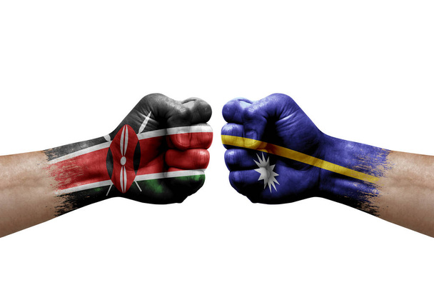 Two hands punch to each others on white background. Country flags painted fists, conflict crisis concept between kenya and nauru - Valokuva, kuva