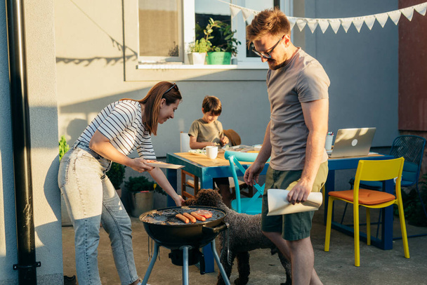 family having barbeque party in their backyard - Fotoğraf, Görsel