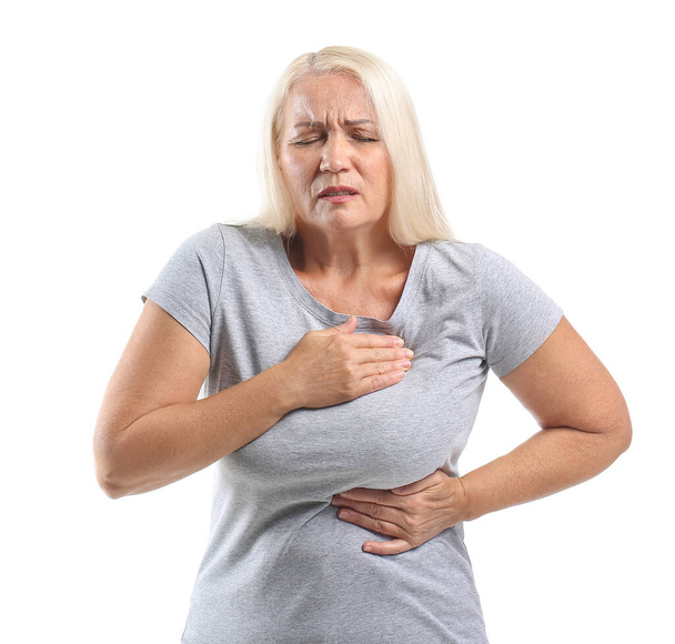 Mature woman suffering from breast pain on white background - Fotó, kép