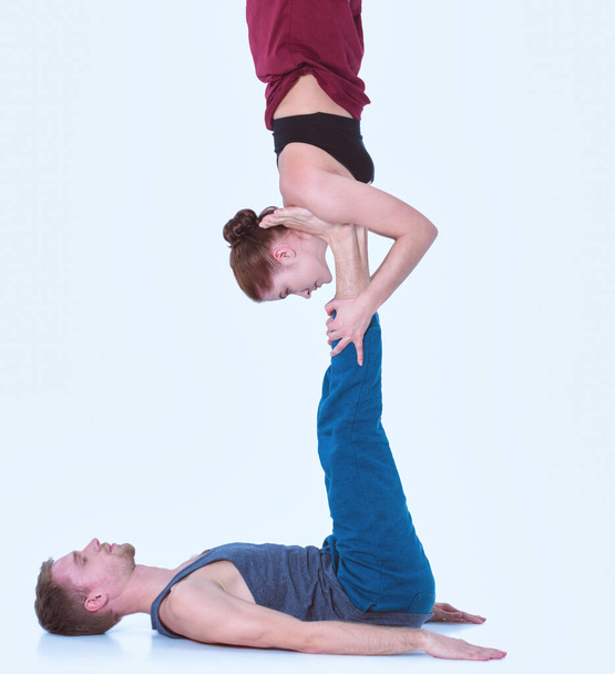 Young athletic couple practicing acroyoga. Balancing in pair. - Fotografie, Obrázek