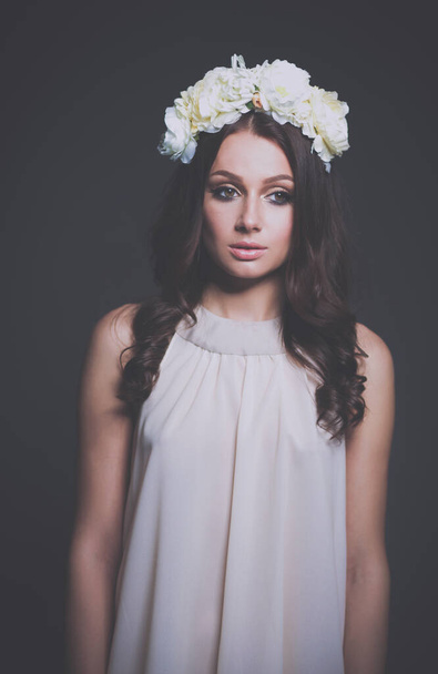 Portrait of a beautiful woman with flowers in her hair. - Fotografie, Obrázek