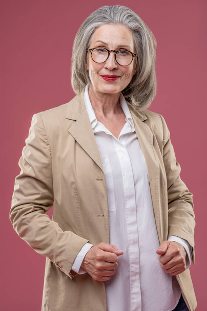 Good-looking woman. Effective mature woman in beige jacket - Fotoğraf, Görsel