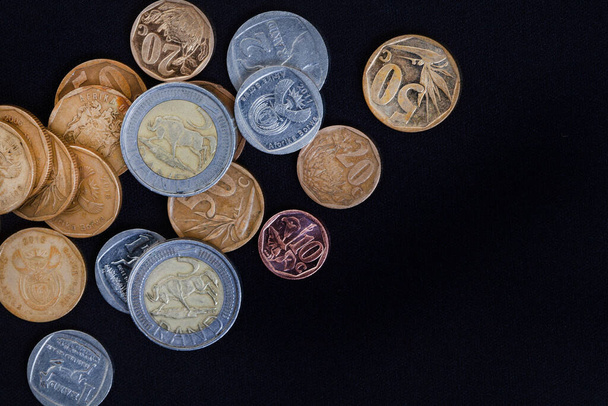 Rand and cents on black, South African currency. Every cent count as costs of living rises - Photo, image