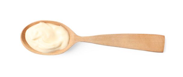 Mayonnaise in wooden spoon isolated on white, top view - Fotoğraf, Görsel