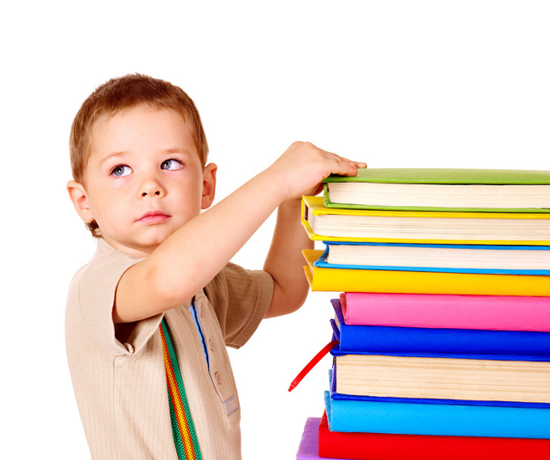 Child holding stack of books. - Fotó, kép